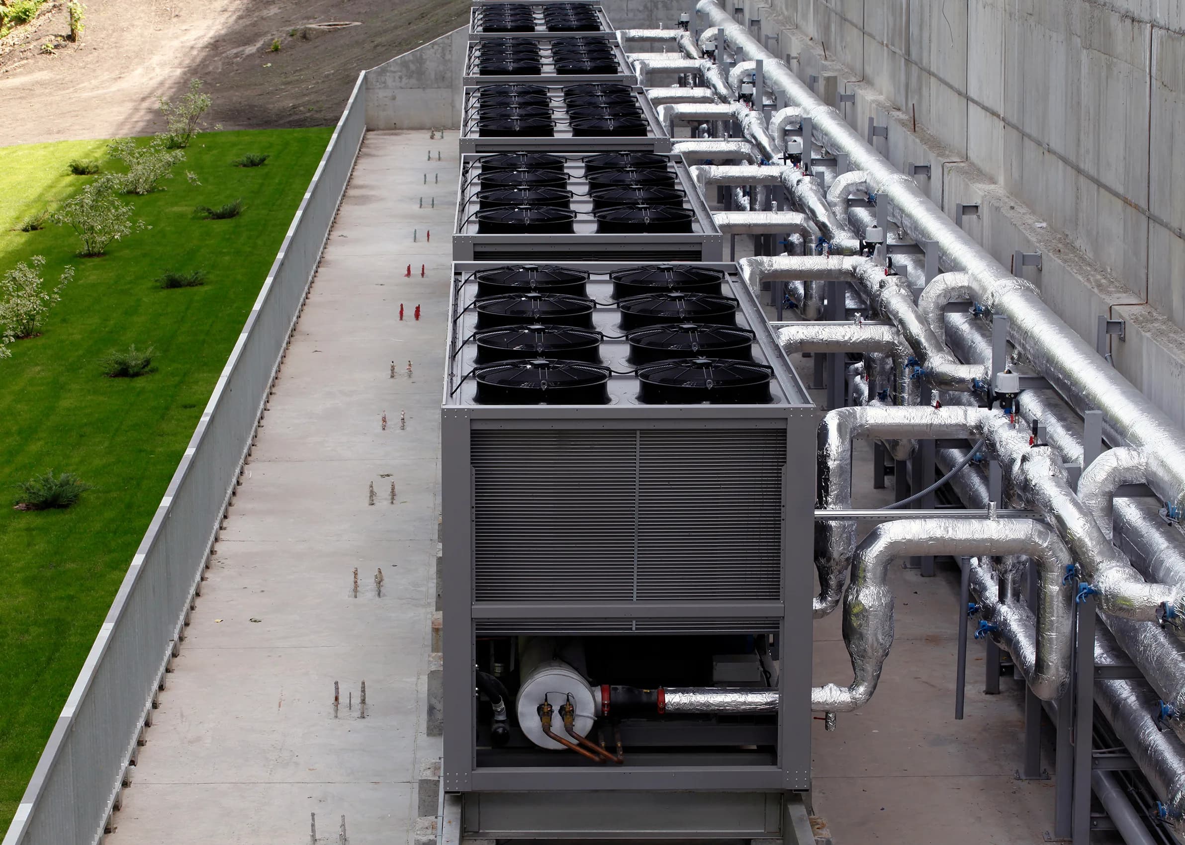Mechanical technician installing CRAH cooling unit in a data center